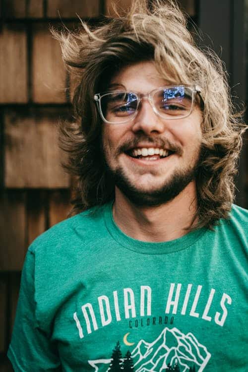 portrait of a young adult male wearing a green t-shirt.